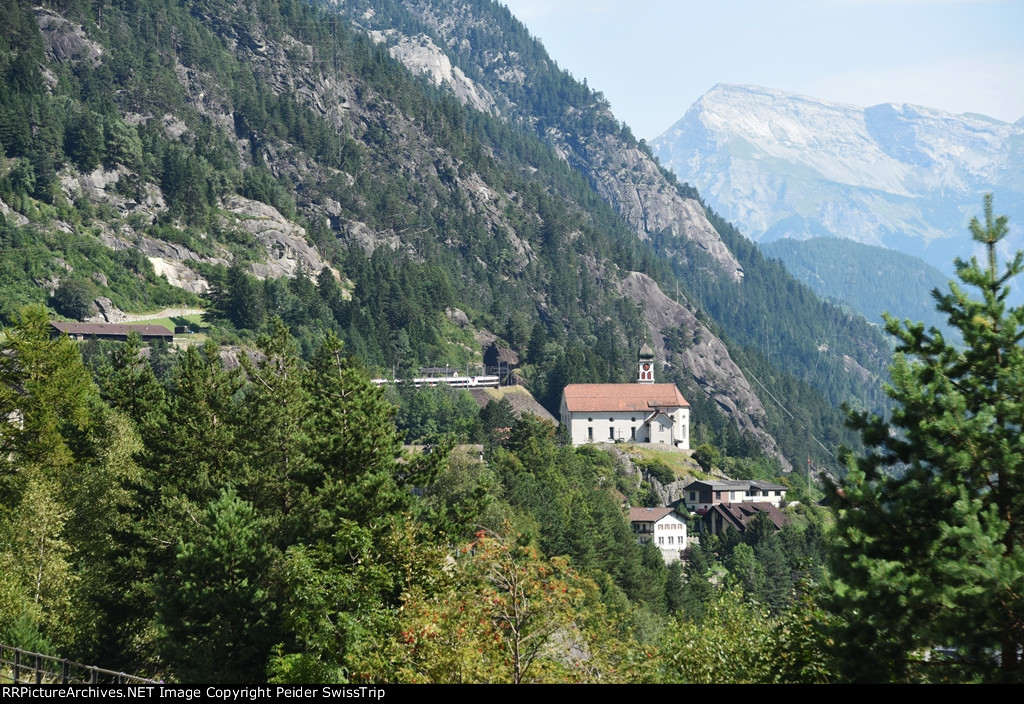 SBB 501 010 passing the famous Wassen church.